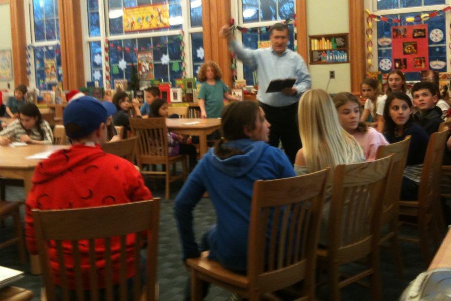 The founding editors, now in sixth grade, speak to the fifth and fourth graders who staff the paper.