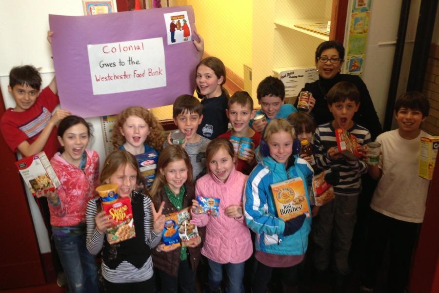 File photo from 2013: Colonial students and Mrs. Kim Norman, the student government advisor, display food collected for Westchester Food Bank.
