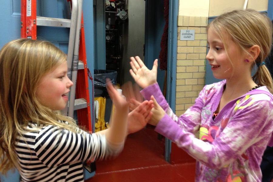 Hand games played by Kate Girolamo (left) and Olivia Orlando.