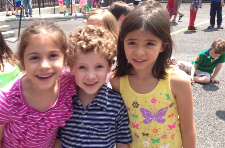 The K-5 buddy program has been around a long time. From left, then Kindergartners Kira Findikyan, Liam Ginsburg and Waverly Nanda on the playground where they learned from their buddies (four years ago).