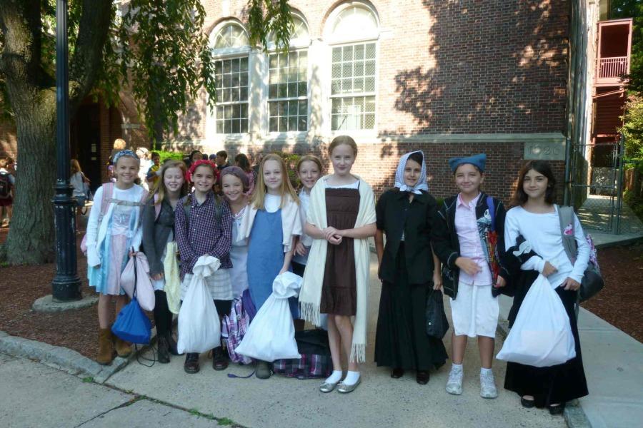Fourth graders from two years ago dressed as immigrants for that year's Immigration Simulation.