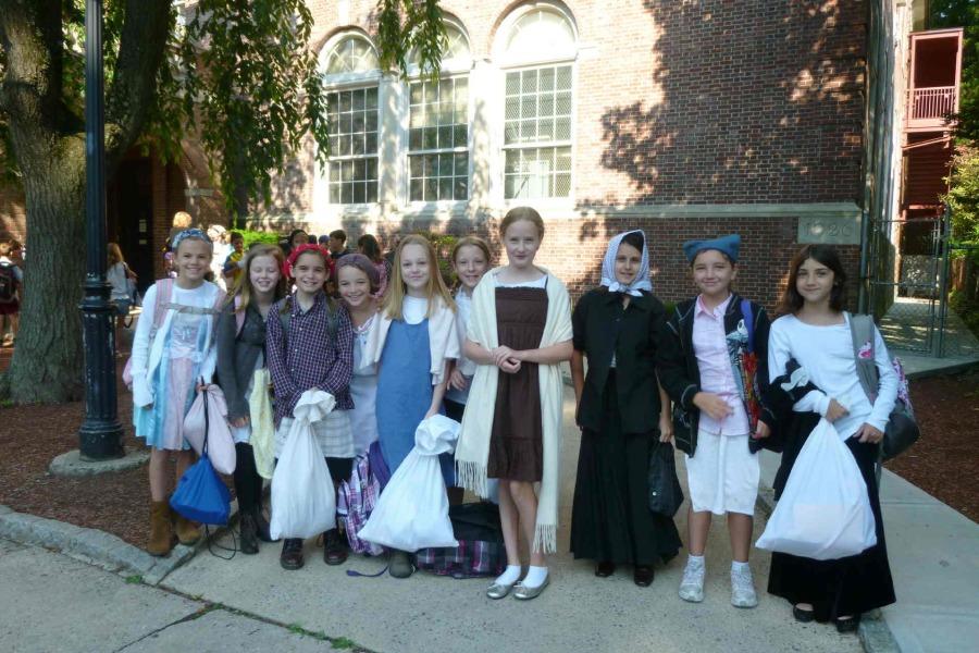 Fourth graders from two years ago dressed as immigrants for that years Immigration Simulation.