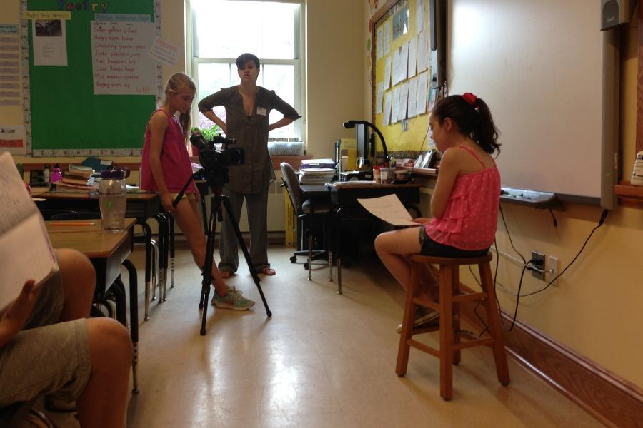 Grayce Cooper (left) filmed Bridget Petti (right) for a memory movie. Picture House teacher Stephanie Schleicher looked on.