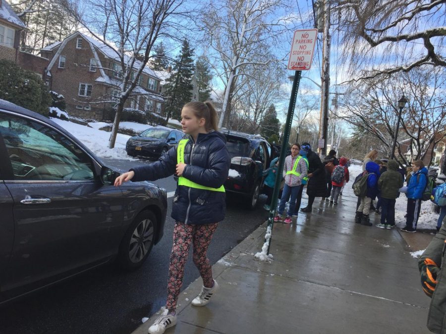 Safety Patrol member Sabine Bushong prepared to help a student out of the car during drop off.